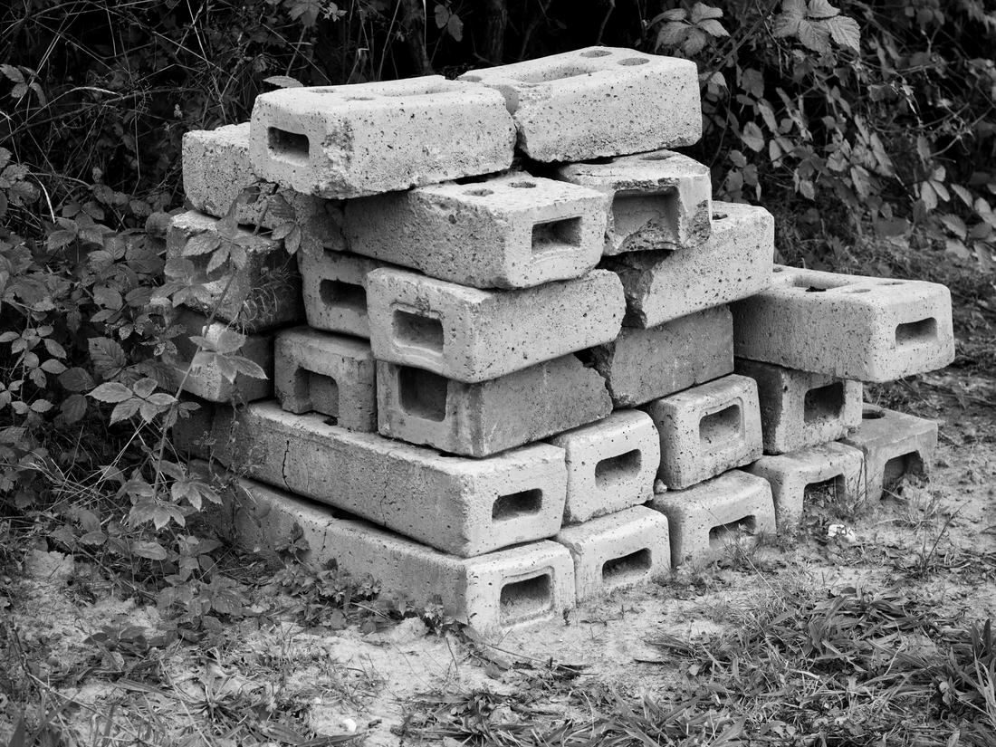 A stack of hollow concrete blocks, in black and white