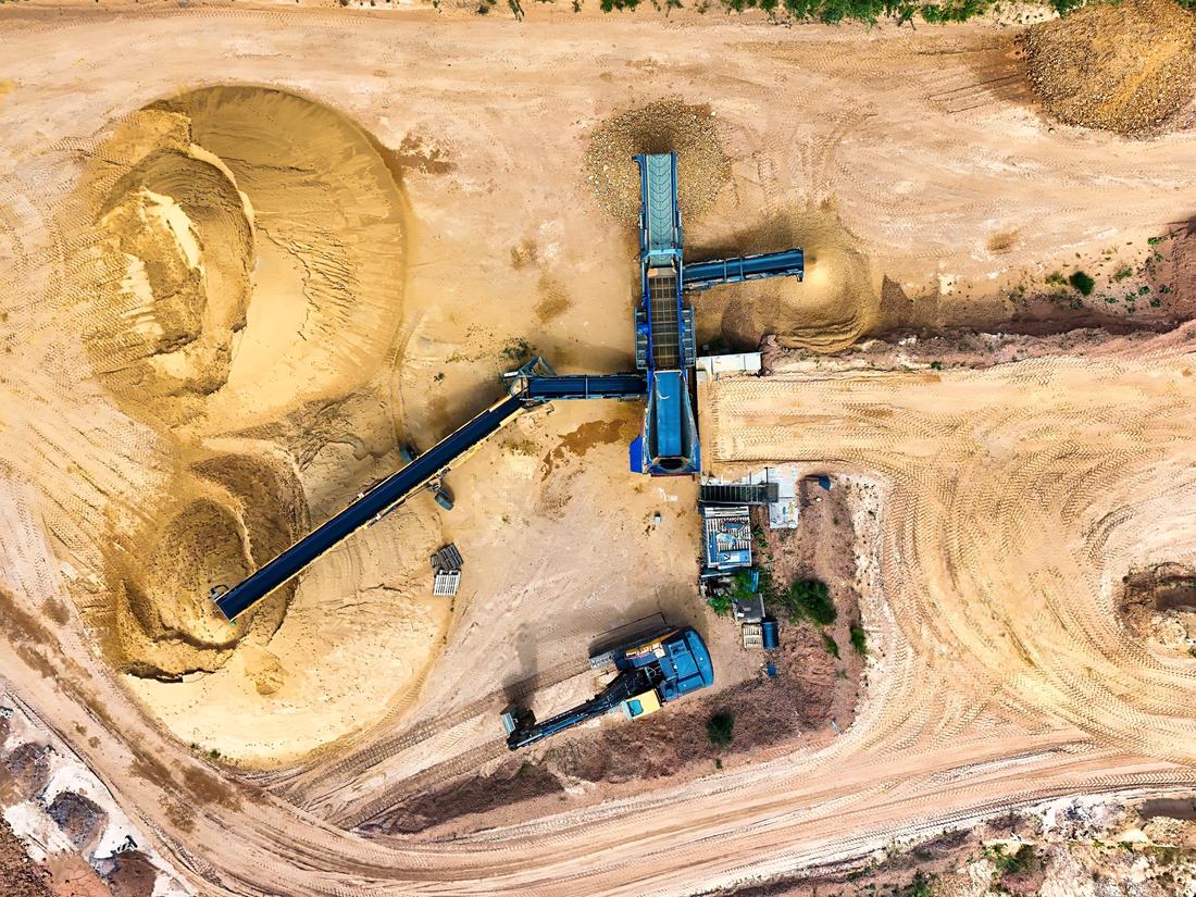 Aerial view of a sand pit, with screening plant and conveyors among the stockpiles